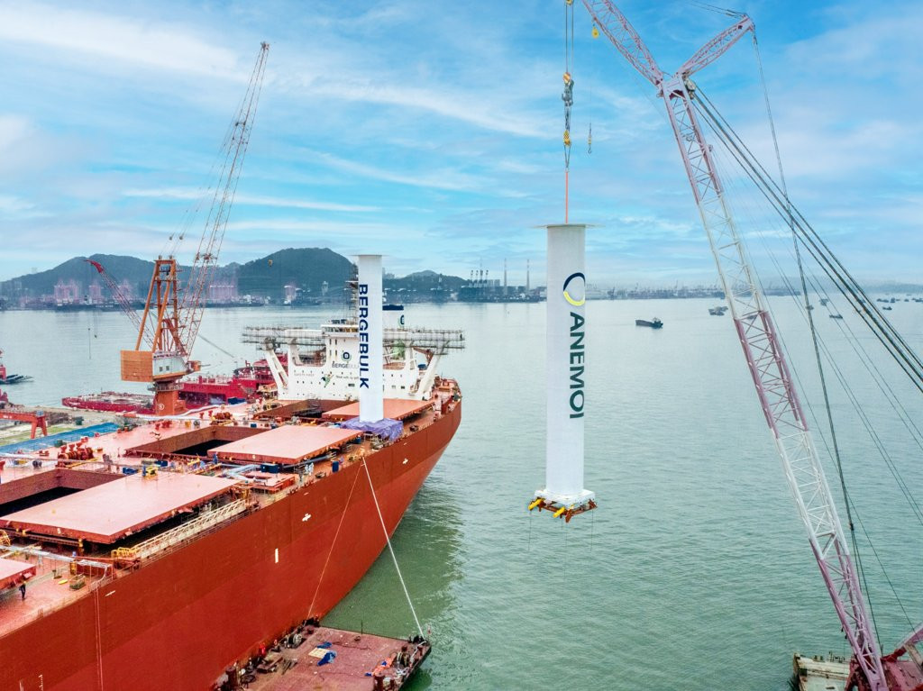Installation of Flettner rotor on cargo vessel using crane at shipyard for wind-assisted propulsion