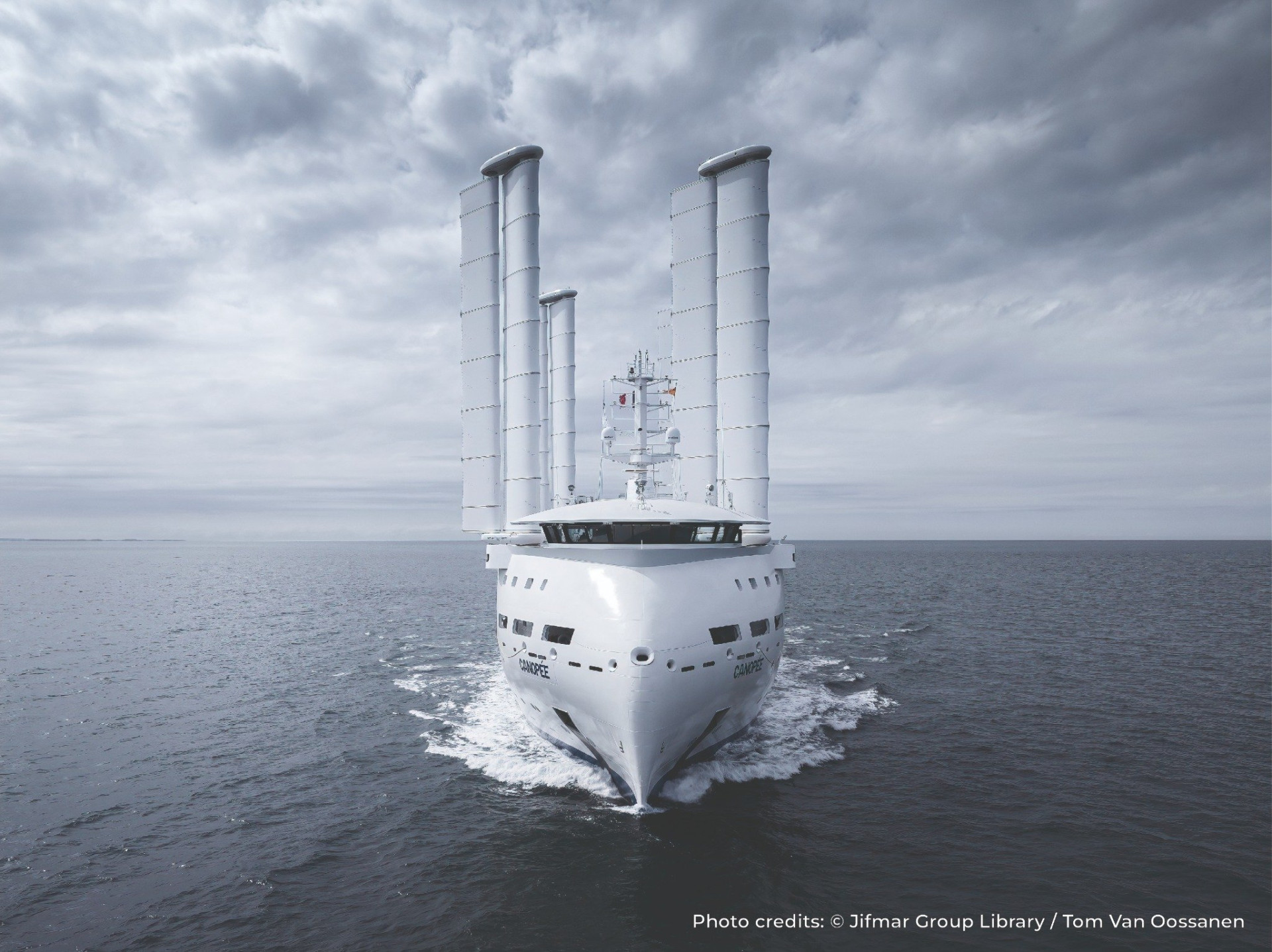 Modern ship at sea with four tall Flettner rotors used for wind-assisted propulsion